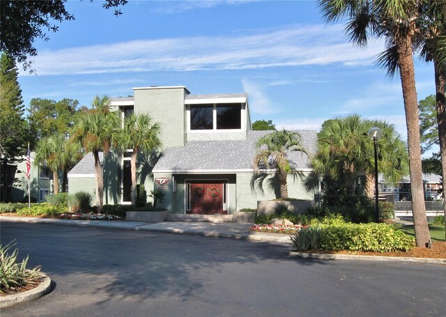 5929 Windhover Dr Unit A02, Orlando, FL 32819 - view of front of home featuring stucco siding and roof with shingles