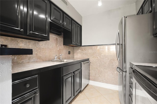5929 Windhover Dr Unit A02, Orlando, FL 32819 - kitchen featuring appliances with stainless steel finishes, dark cabinets, and light tile patterned floors