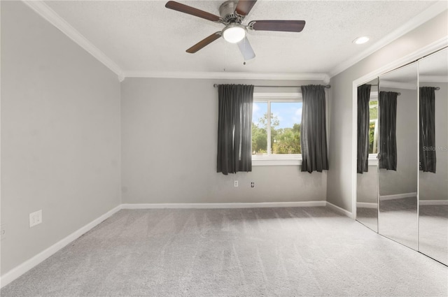 5929 Windhover Dr Unit A02, Orlando, FL 32819 - unfurnished bedroom with crown molding, a closet, carpet floors, a textured ceiling, and a ceiling fan