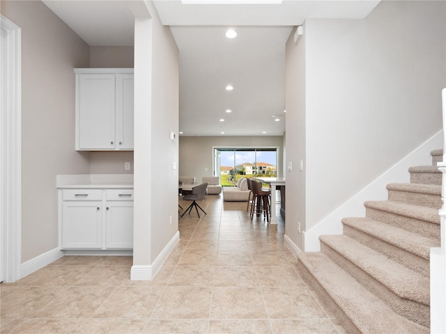 interior space with white cabinetry and light tile patterned floors