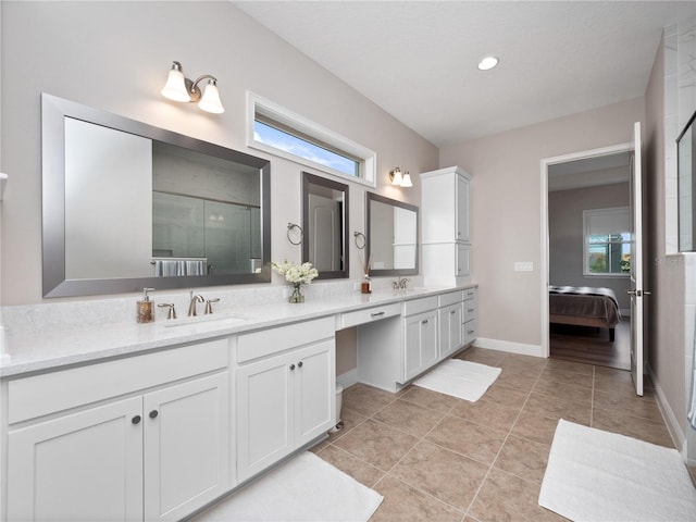 bathroom featuring tile patterned flooring, vanity, and an enclosed shower