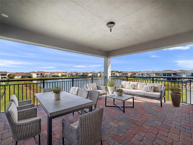 view of patio / terrace with an outdoor living space and a water view