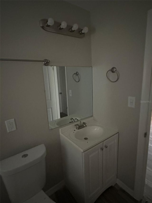 bathroom featuring vanity and toilet