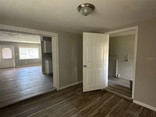 spare room featuring dark wood-type flooring