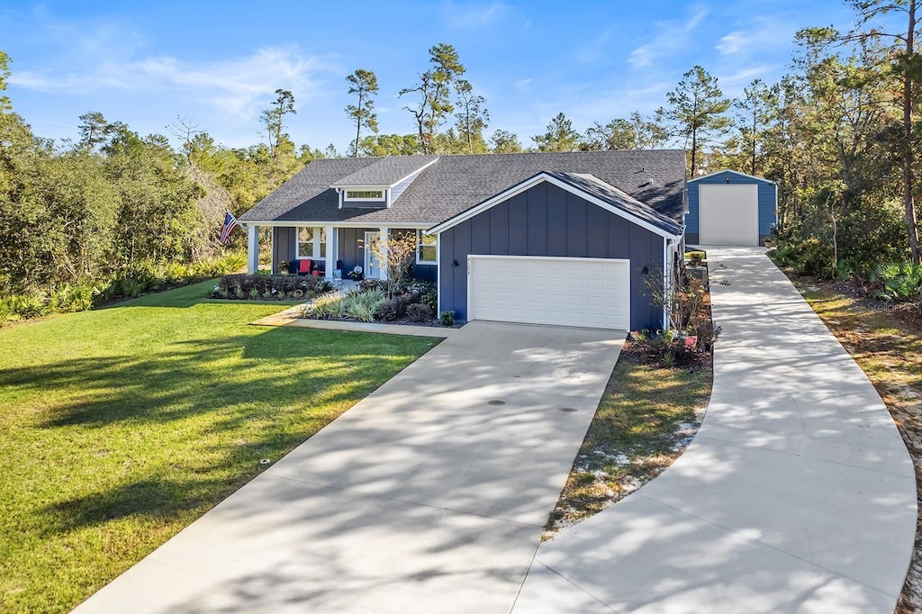 view of front of property with a front lawn, a porch, and a garage