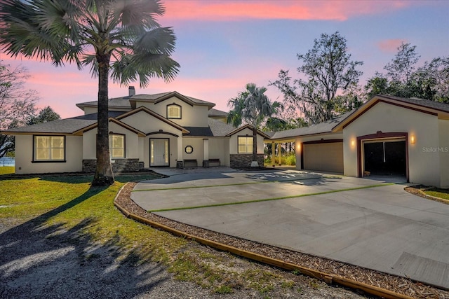 view of front facade with a yard and a garage