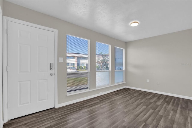 entryway featuring a textured ceiling and dark hardwood / wood-style floors