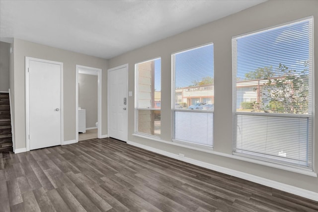 spare room with dark wood-type flooring