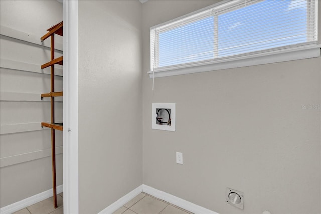 clothes washing area featuring hookup for an electric dryer, light tile patterned flooring, and hookup for a washing machine