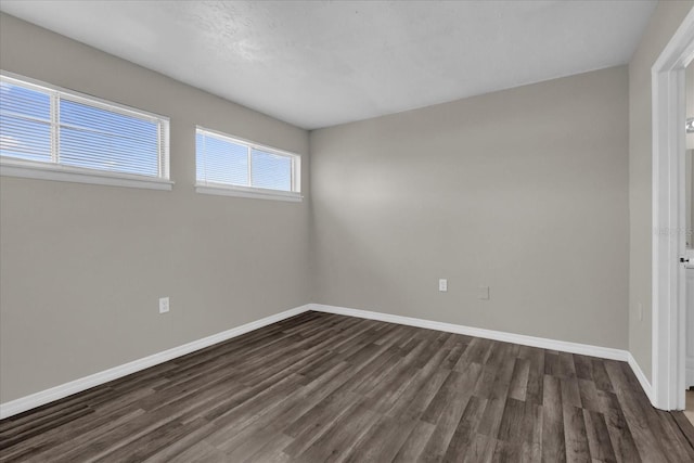 empty room with dark wood-type flooring