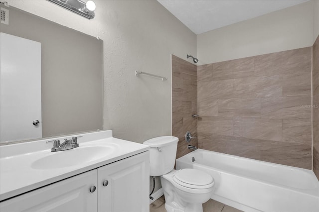 full bathroom featuring tile patterned floors, vanity, tiled shower / bath combo, and toilet