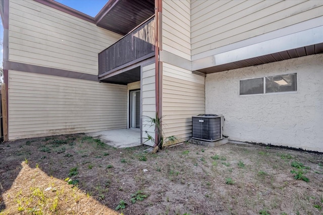 entrance to property featuring a balcony and central air condition unit