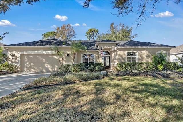 ranch-style house featuring a front yard and a garage