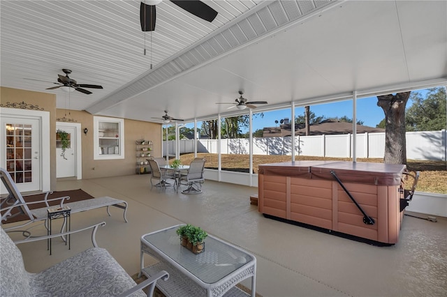 sunroom / solarium featuring beamed ceiling and plenty of natural light