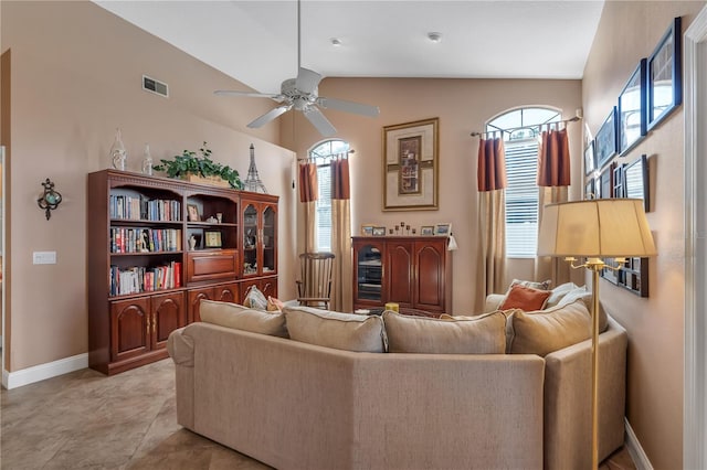 living room featuring plenty of natural light, lofted ceiling, and ceiling fan