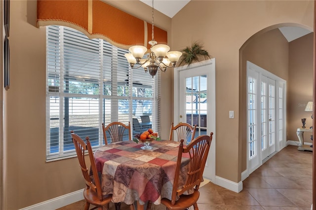 dining room with tile patterned floors, plenty of natural light, a chandelier, and french doors