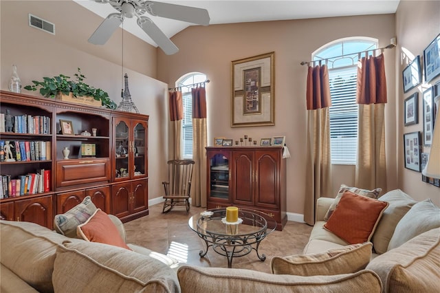 sitting room with ceiling fan, a healthy amount of sunlight, light tile patterned flooring, and vaulted ceiling