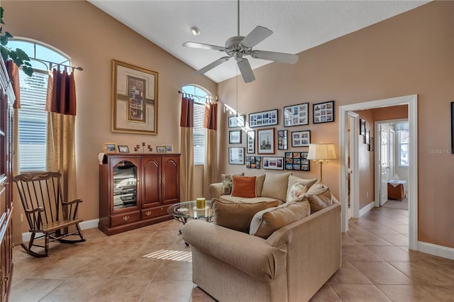 tiled living room with ceiling fan, lofted ceiling, and a textured ceiling