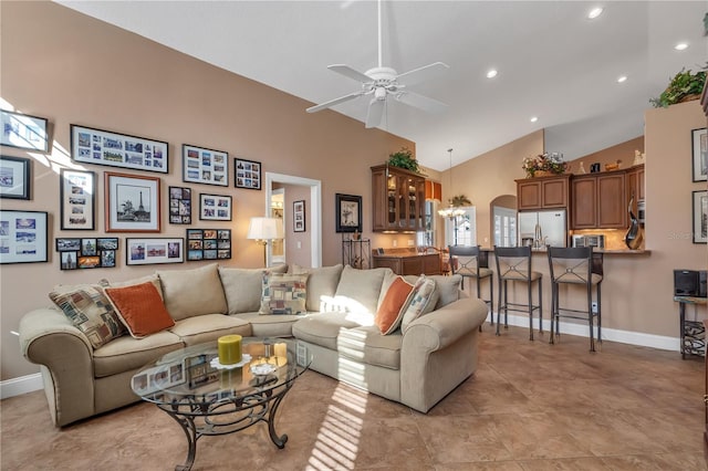 living room featuring ceiling fan and high vaulted ceiling