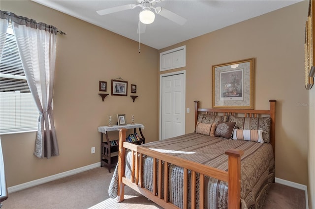 carpeted bedroom with multiple windows and ceiling fan