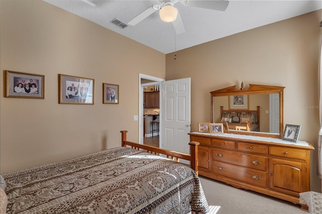 carpeted bedroom featuring ceiling fan and a textured ceiling