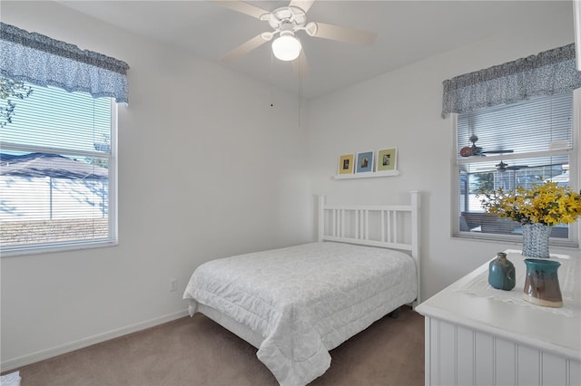 carpeted bedroom with multiple windows and ceiling fan