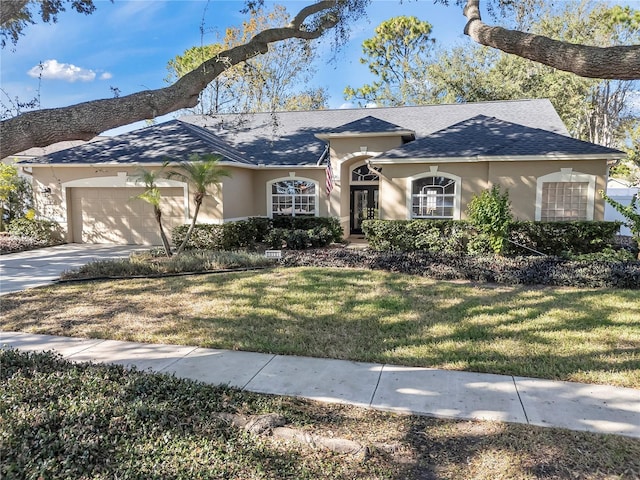 single story home featuring a garage and a front yard