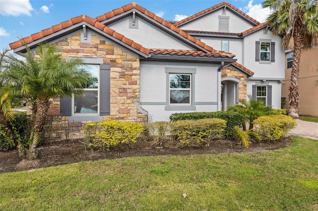 mediterranean / spanish house featuring a front yard