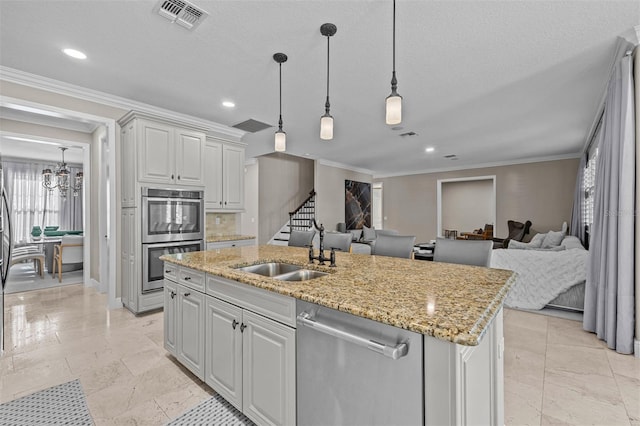 kitchen with sink, ornamental molding, a kitchen island with sink, and appliances with stainless steel finishes