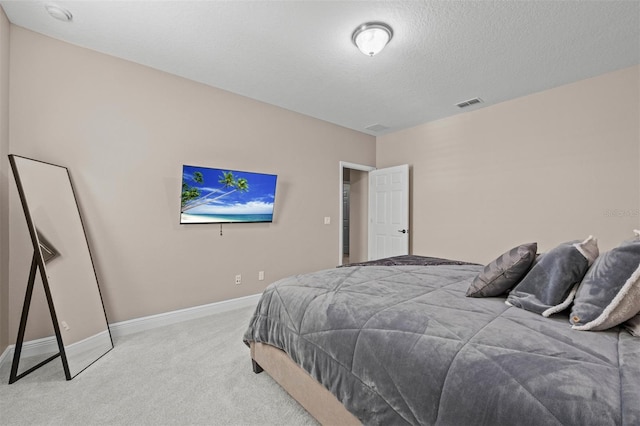 carpeted bedroom with a textured ceiling