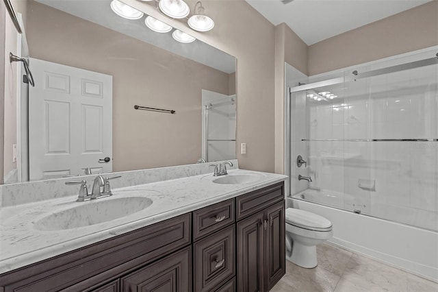 full bathroom featuring vanity, toilet, and shower / bath combination with glass door