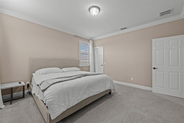 carpeted bedroom with a textured ceiling and crown molding