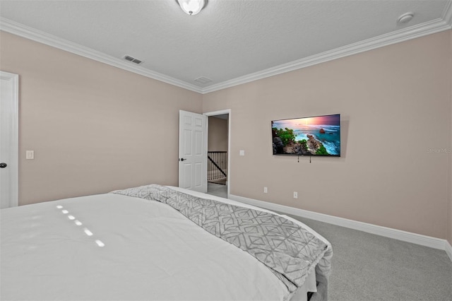 carpeted bedroom with a textured ceiling and crown molding