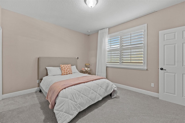 carpeted bedroom with a textured ceiling