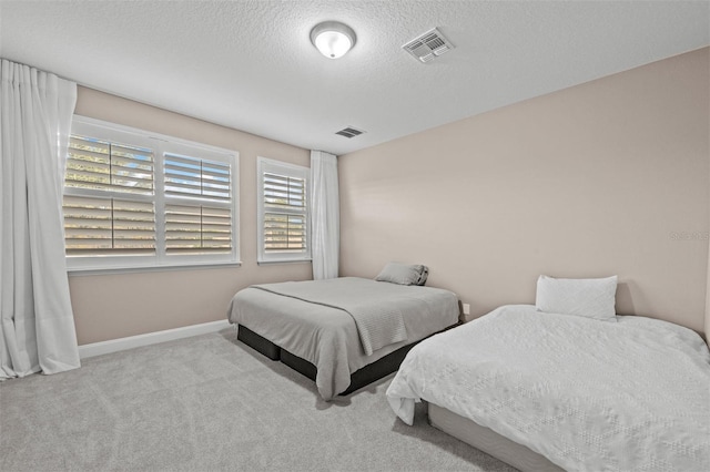 carpeted bedroom with a textured ceiling