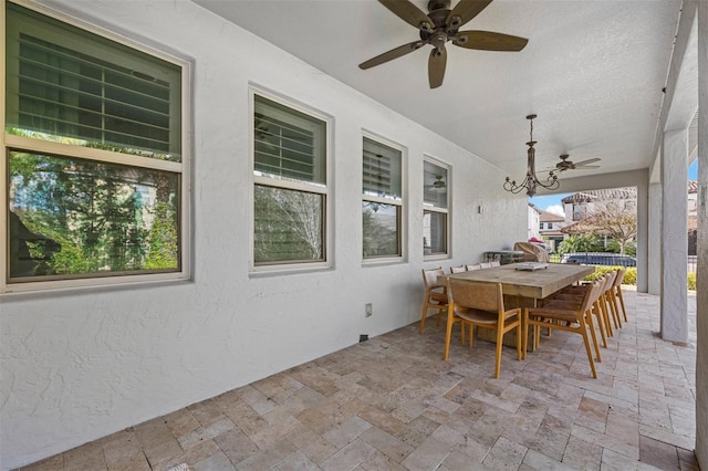 exterior space featuring a wealth of natural light and a chandelier