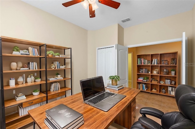 tiled office featuring ceiling fan