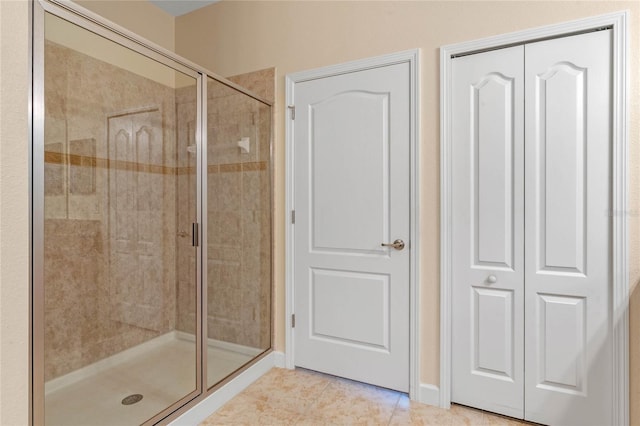 bathroom with tile patterned floors and walk in shower