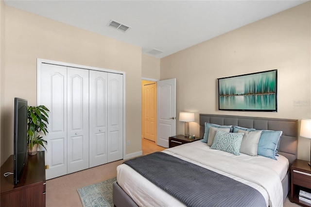 bedroom featuring light carpet and a closet