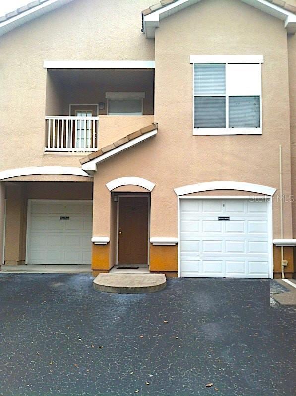 view of front of house featuring a balcony and a garage