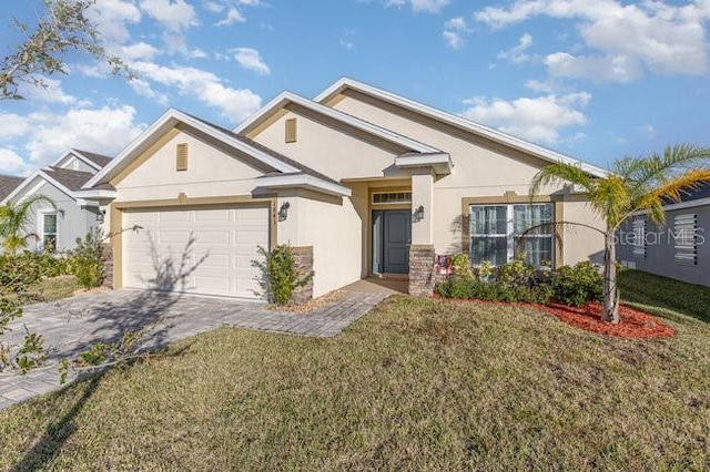 view of front of property featuring a garage and a front lawn