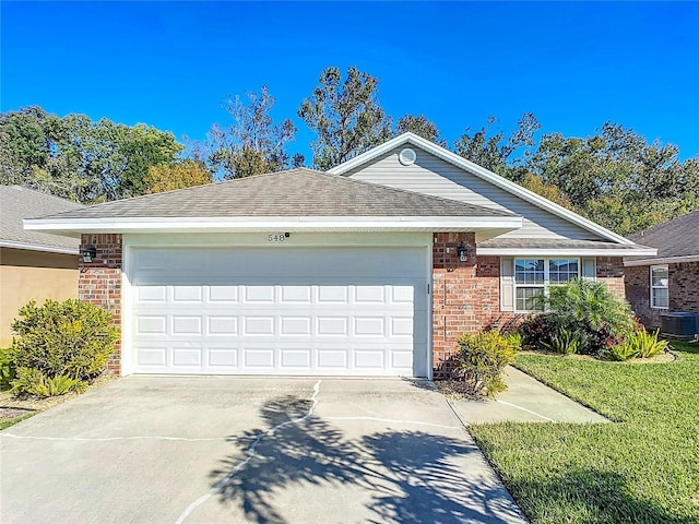 ranch-style home with central air condition unit and a garage