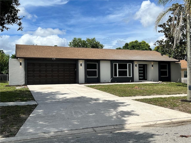 ranch-style house featuring a front lawn and a garage