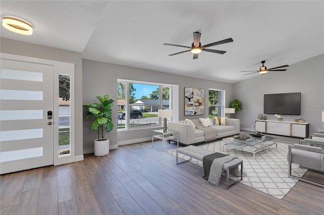 living room featuring ceiling fan and light hardwood / wood-style flooring