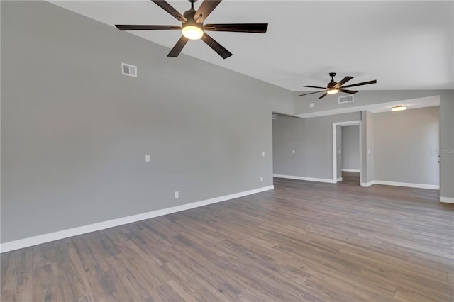 unfurnished room featuring ceiling fan, hardwood / wood-style floors, and vaulted ceiling