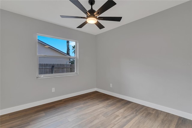 empty room featuring hardwood / wood-style flooring and ceiling fan