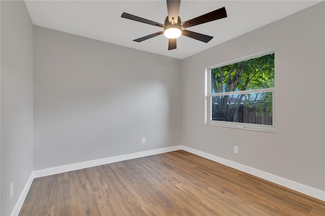 spare room with ceiling fan and hardwood / wood-style flooring