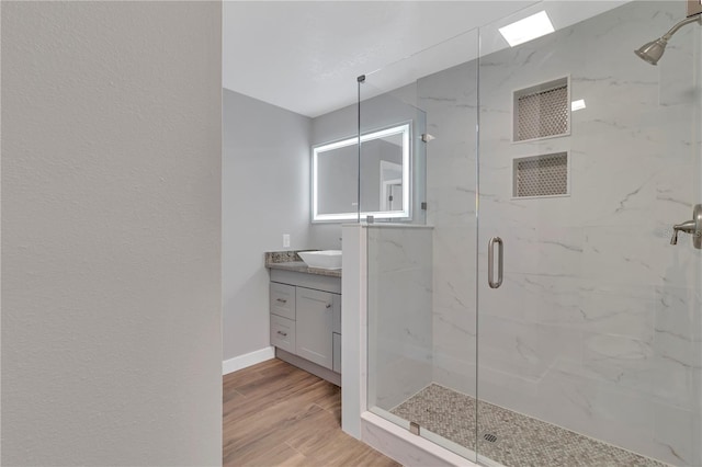 bathroom featuring vanity, wood-type flooring, and an enclosed shower