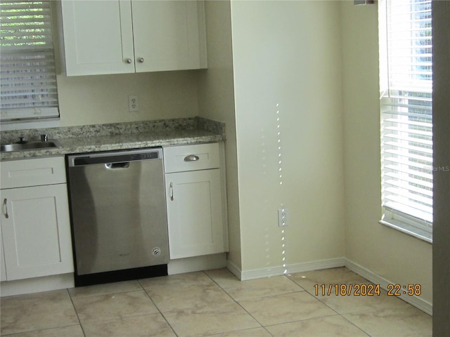 kitchen with dishwasher, white cabinets, and light stone counters