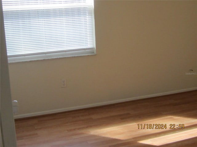 empty room with hardwood / wood-style flooring